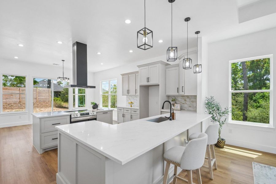 Clean lines and smooth stone countertops define this modern, open culinary space. Clean lines and smooth stone countertops define this modern, open culinary space.