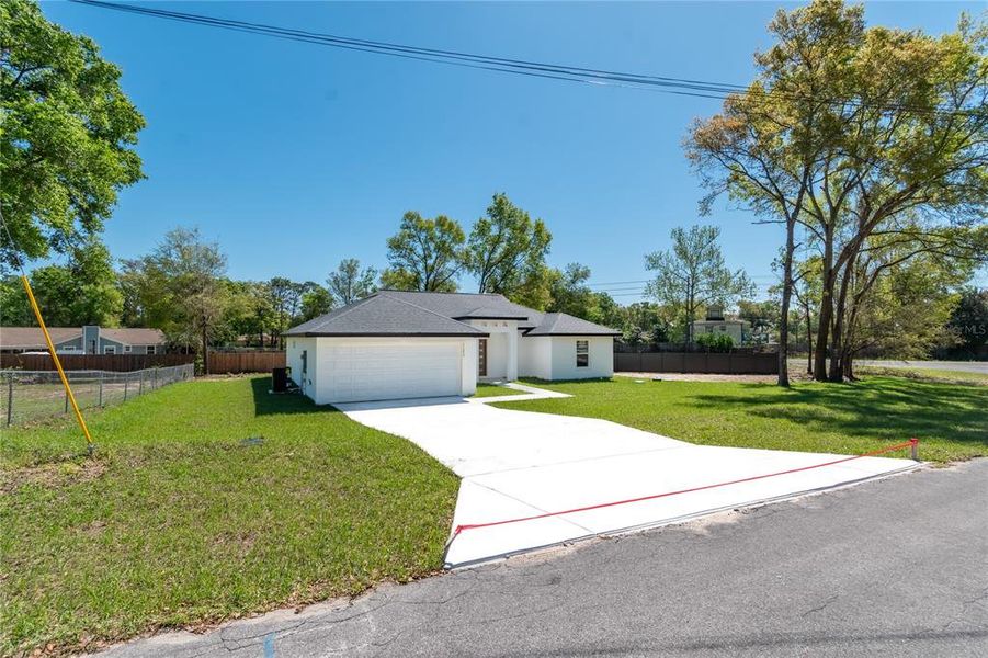 Front exterior of a new home in , Belleview, FL, highlighting curb appeal (Image 27). Front exterior of a new home in , Belleview, FL, highlighting curb appeal (Image 27).