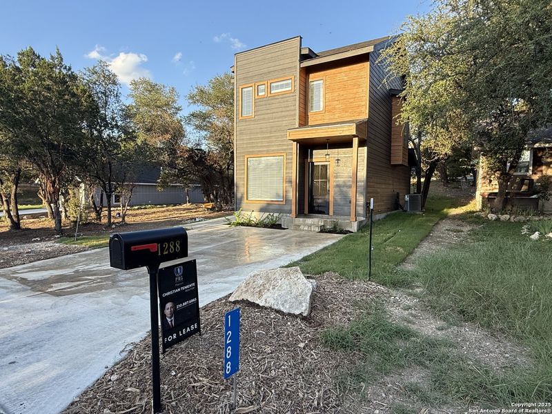 Front exterior of a new home in , Canyon Lake, TX, highlighting curb appeal (Image 14).