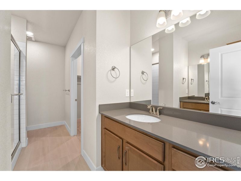 Primary bathroom with separate dual vanities