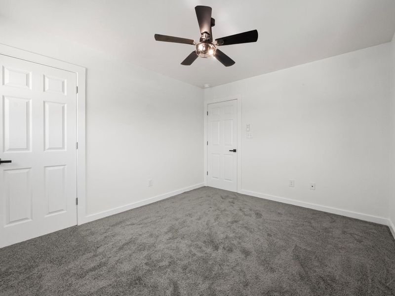 White walls and trim with dark gray carpeting