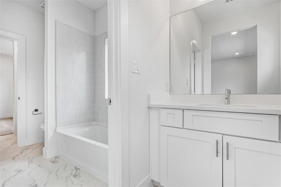 Bathroom with tile patterned floors, vanity, and toilet