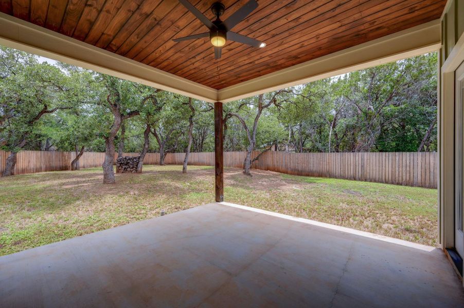 A spacious covered patio provides a serene transition to the private, tree-lined yard. A spacious covered patio provides a serene transition to the private, tree-lined yard.