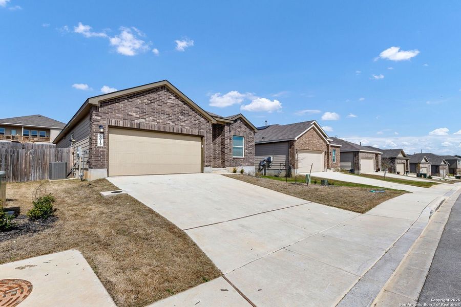 Front exterior of a new home in Hidden Trails: Coastline Collection, Bulverde, TX, highlighting curb appeal (Image 21).