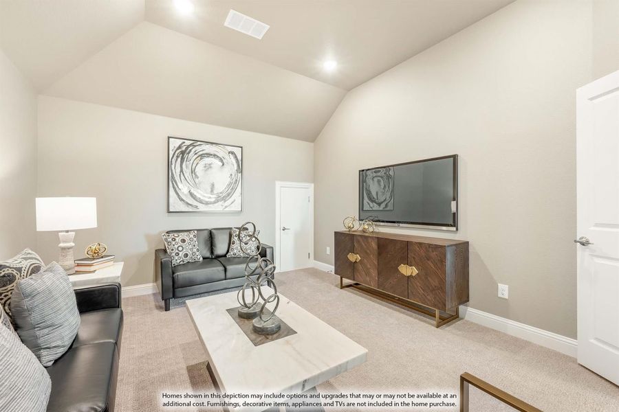 Living room with vaulted ceiling, black leather sofa, wall-mounted TV, and wood media console on beige carpet