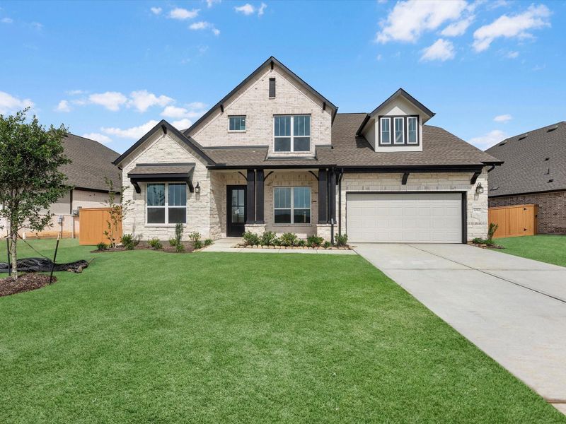 Front exterior of a new home in Wildrye, Waller, TX, highlighting curb appeal (Image 2). Front exterior of a new home in Wildrye, Waller, TX, highlighting curb appeal (Image 2).