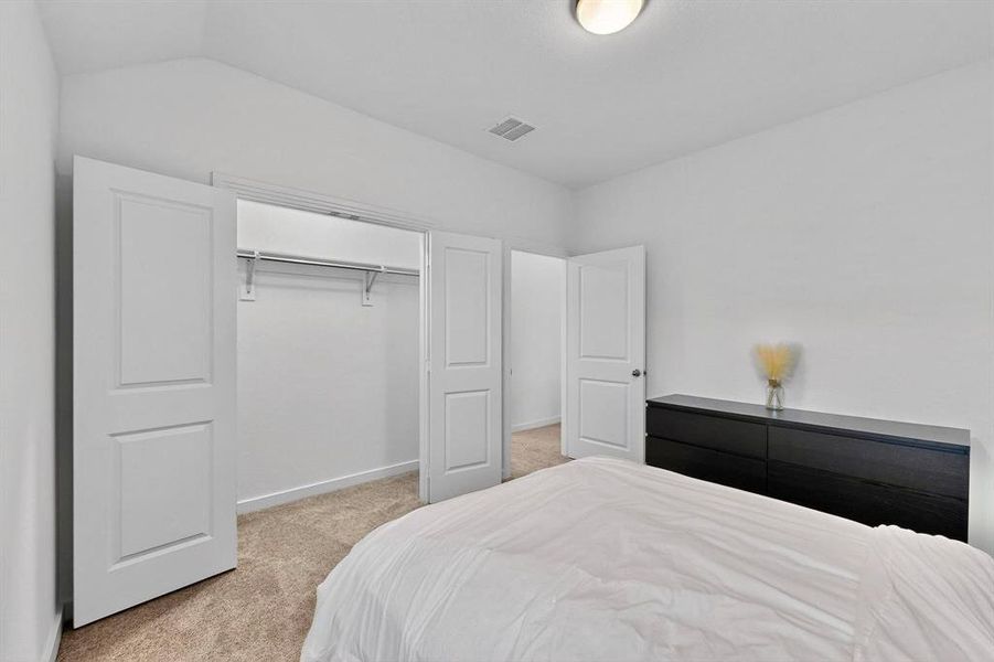 Bedroom with light carpet and a closet Bedroom with light carpet and a closet