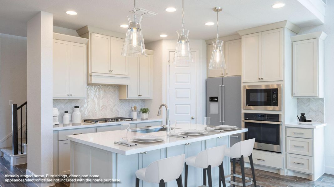 Kitchen featuring decorative backsplash, wood tiled floors, stainless steel appliances, recessed lighting, and an island with sink Kitchen featuring decorative backsplash, wood tiled floors, stainless steel appliances, recessed lighting, and an island with sink