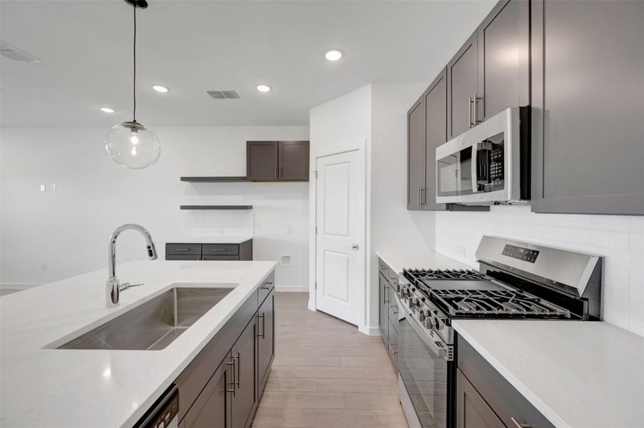 Stunning kitchen with grey cabinets and floating shelves