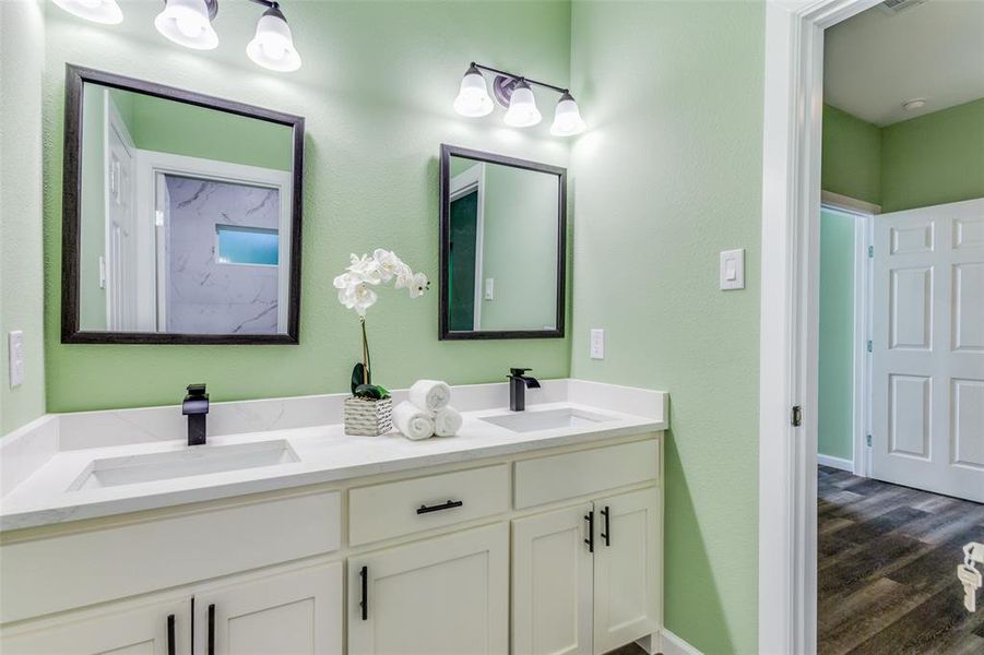 Bathroom with double sink vanity and hardwood / wood-style floors