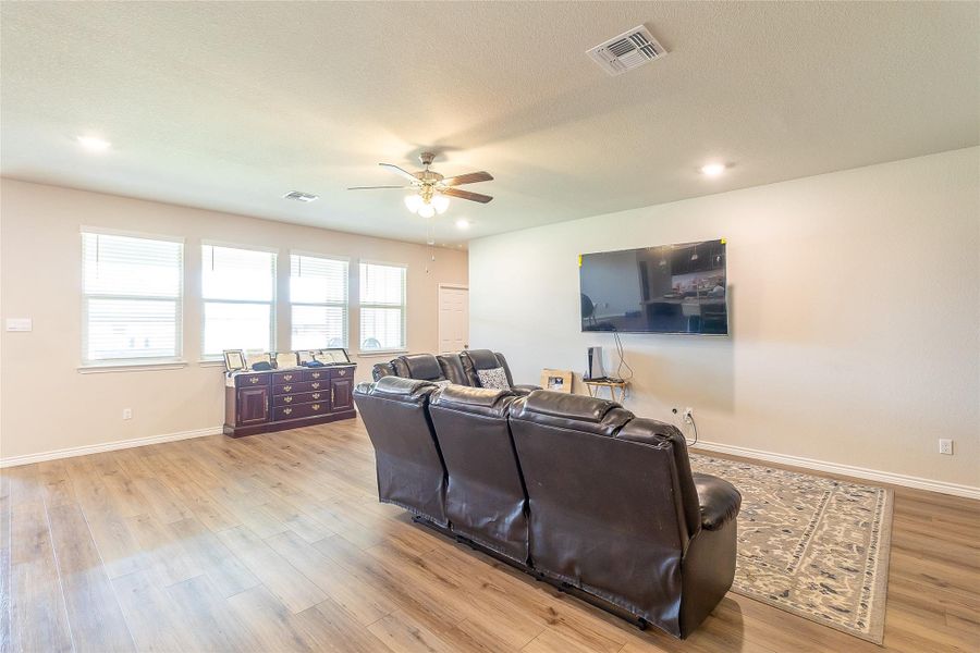 An inviting gathering space showcases rich wood flooring and abundant natural light.