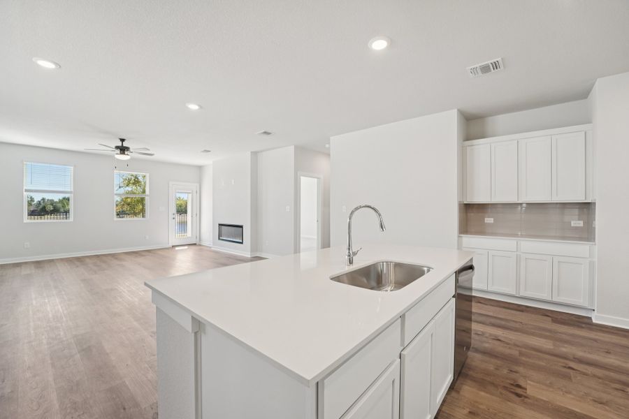 A kitchen with white cabinets.