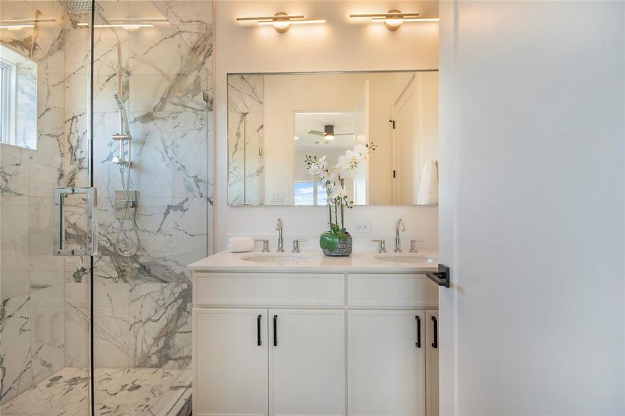 Bathroom with a marble finish shower and double vanity Bathroom with a marble finish shower and double vanity