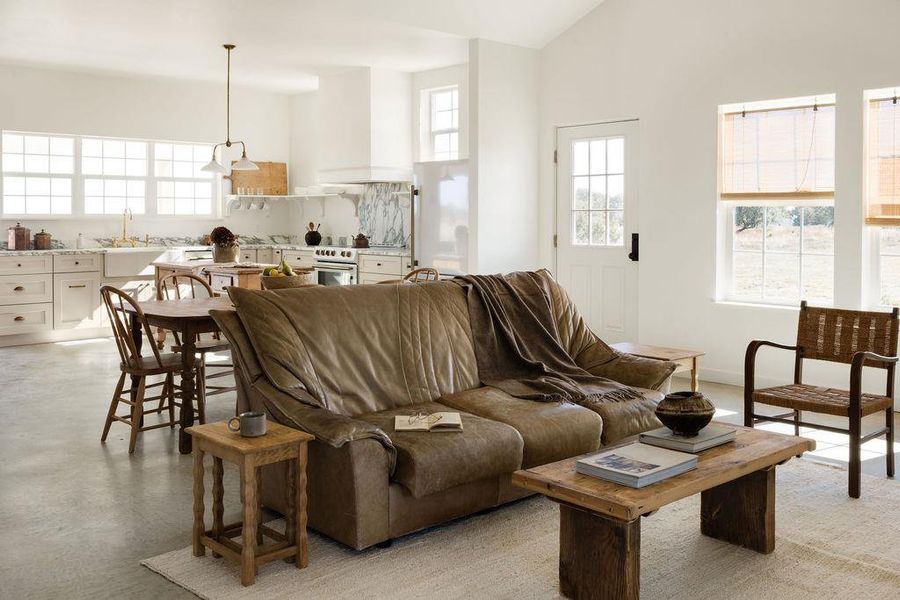 Living room with finished concrete floors and lofted ceiling