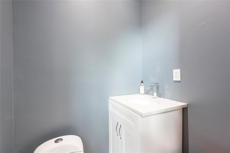 Bathroom featuring vanity and toilet Bathroom featuring vanity and toilet