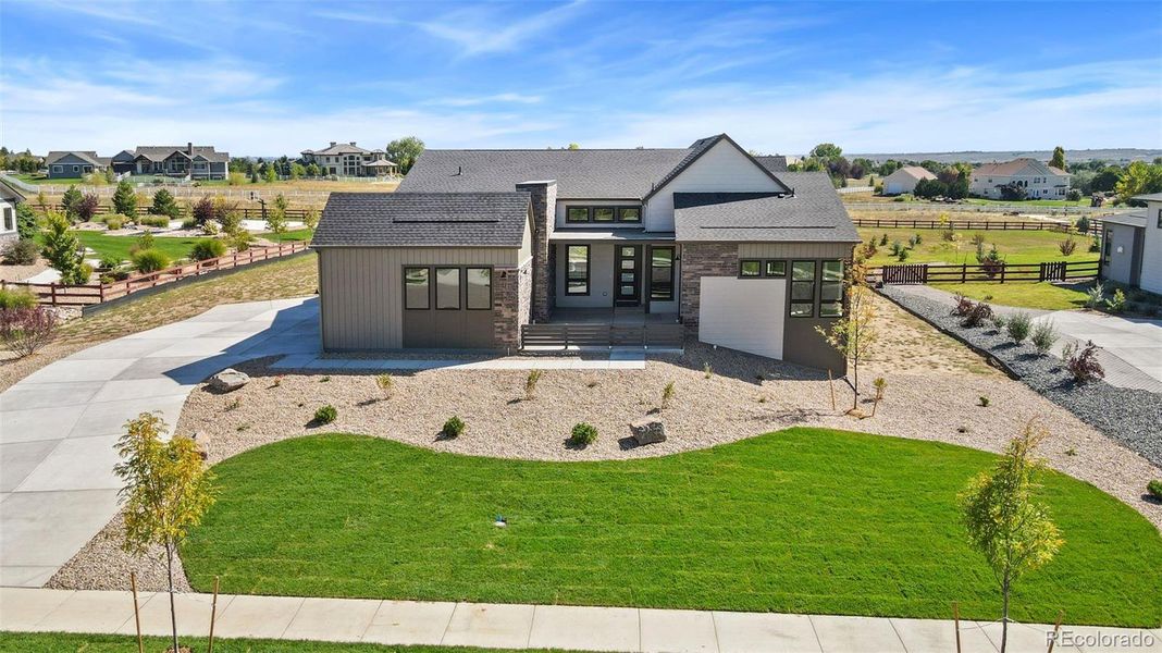 Front exterior of a new home in Acadia at RainDance, Windsor, CO, highlighting curb appeal (Image 14).
