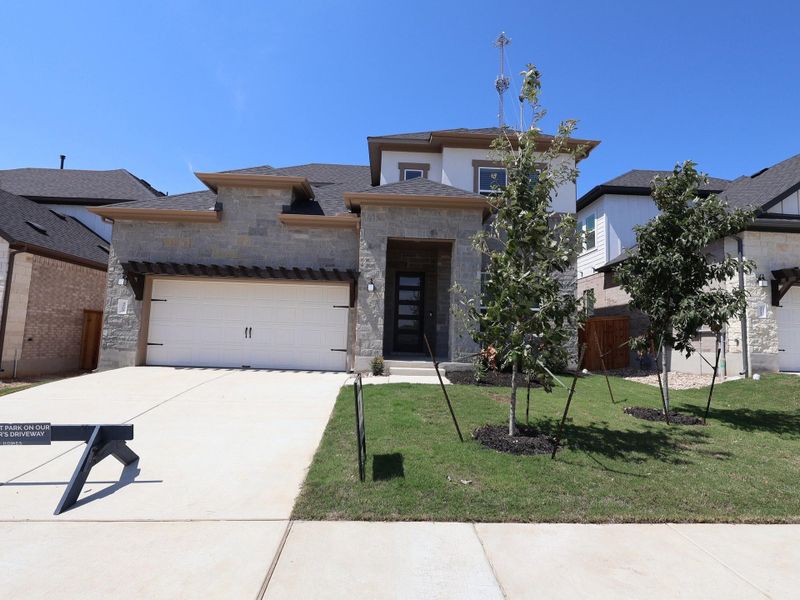 Front exterior of a new home in Edgewood, Leander, TX, highlighting curb appeal (Image 22).