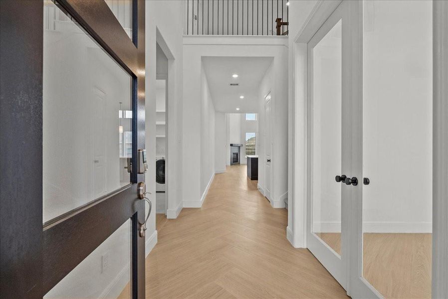 Enter through the front door to soaring ceilings and an abundance of natural light