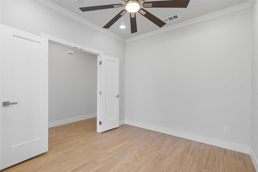 Empty room featuring ornamental molding, light wood finished floors, recessed lighting, and ceiling fan Empty room featuring ornamental molding, light wood finished floors, recessed lighting, and ceiling fan