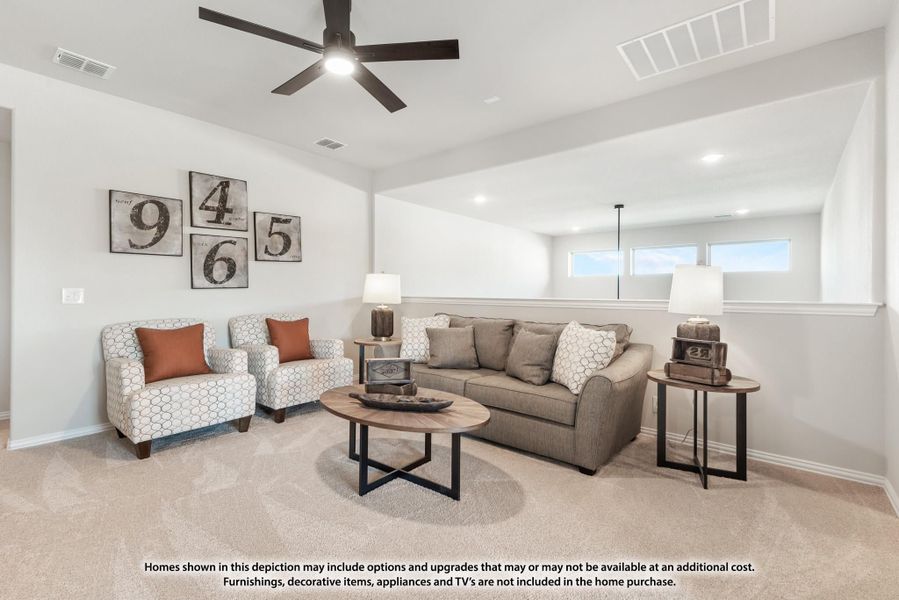 Living room with gray sofa, two accent chairs, round coffee table, and ceiling fan over carpet flooring