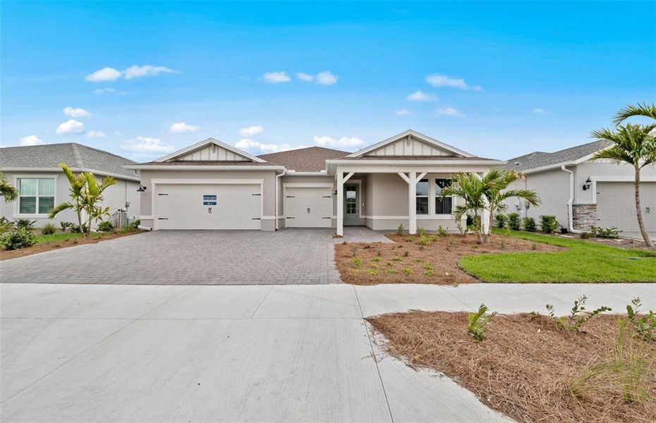 Front exterior of a new home in Reagan Landing, Bradenton, FL, highlighting curb appeal (Image 1). Front exterior of a new home in Reagan Landing, Bradenton, FL, highlighting curb appeal (Image 1).
