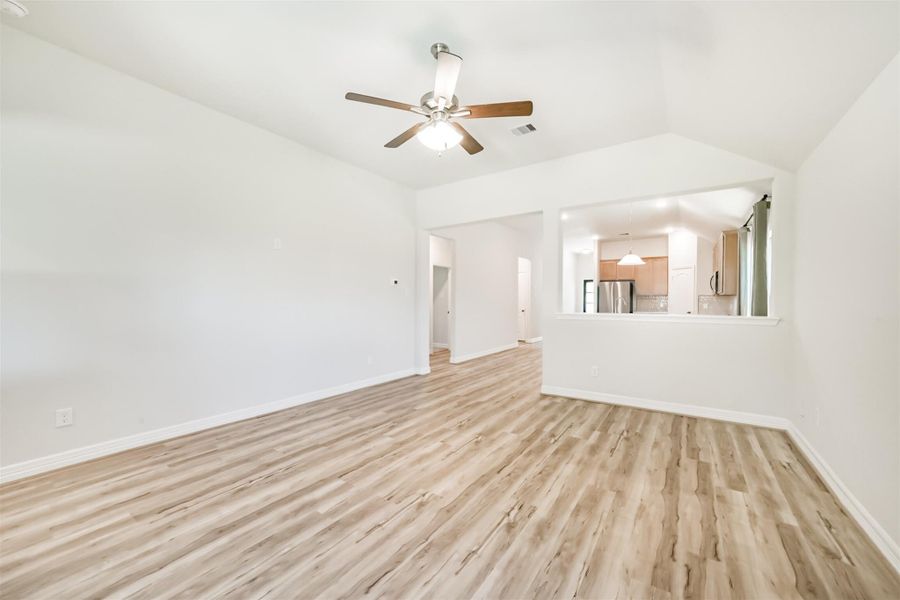 A half wall separates the living room from the breakfast area, adding a defined sense of space while keeping the layout open and cohesive. A half wall separates the living room from the breakfast area, adding a defined sense of space while keeping the layout open and cohesive.