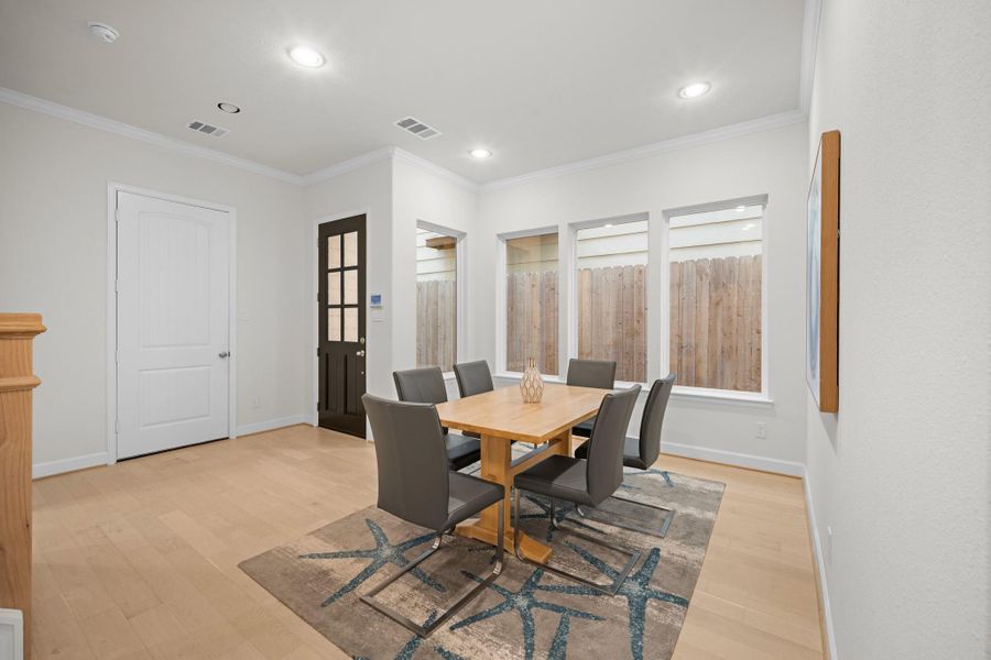 The dining room from the entry side shows the full layout: front door, formal dining, and a straight sight line back to the living area — a floor plan that makes sense the moment you walk in. The dining room from the entry side shows the full layout: front door, formal dining, and a straight sight line back to the living area — a floor plan that makes sense the moment you walk in.