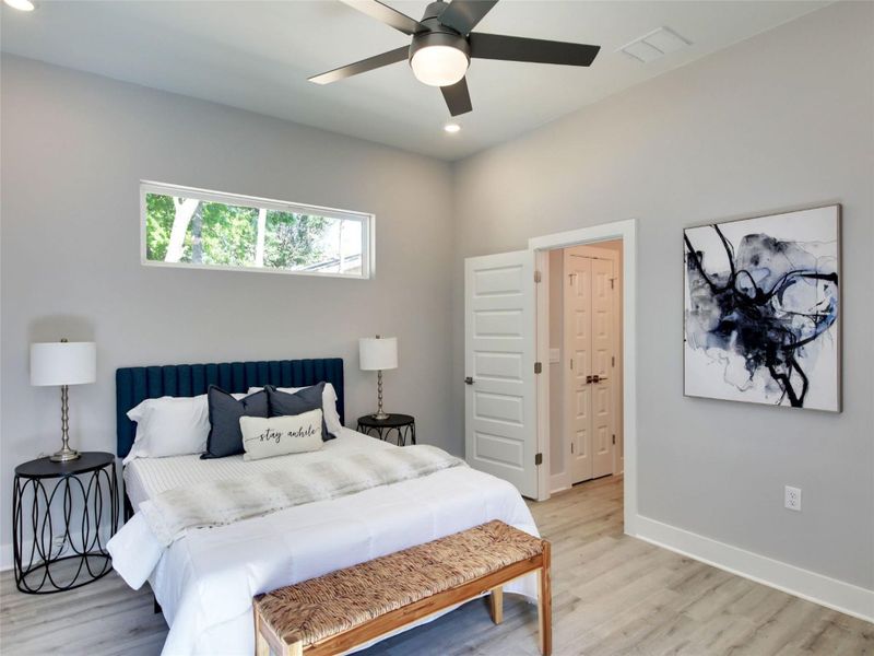 Bedroom featuring light wood-type flooring, ceiling fan, and recessed lighting