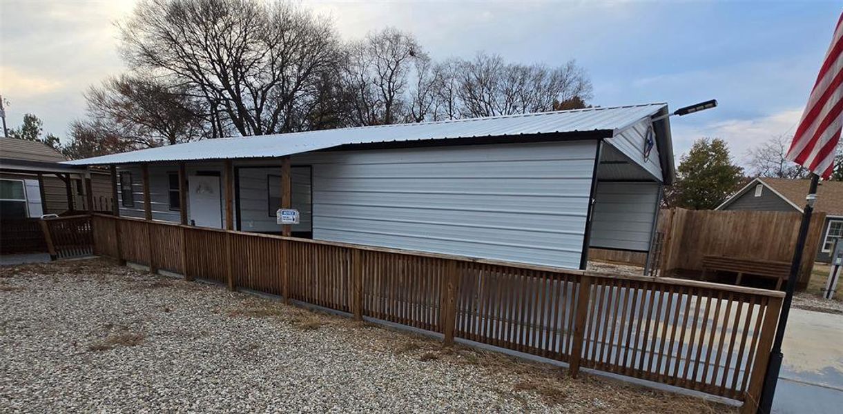 View of side of home with a metal roof