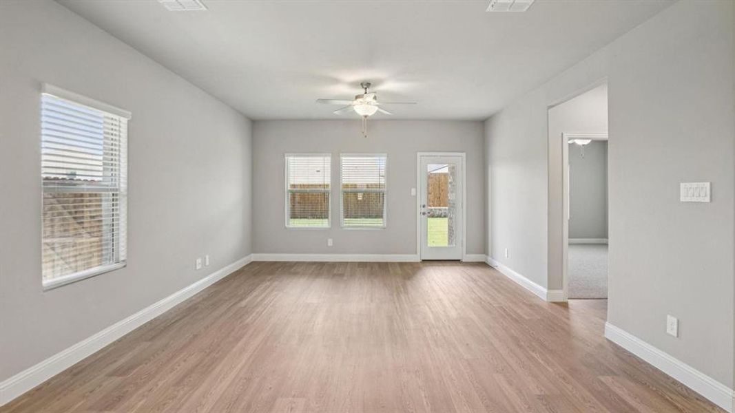Unfurnished room with light wood-style floors and a ceiling fan