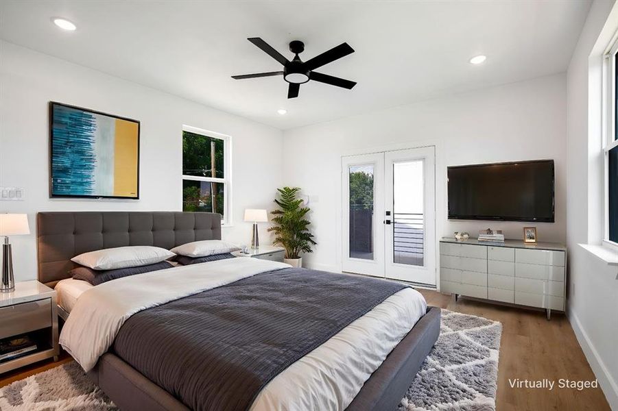 Bedroom with wood finished floors, a ceiling fan, access to outside, recessed lighting, and french doors