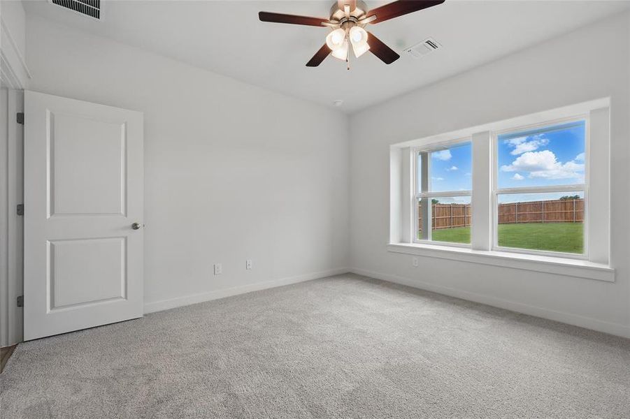 Spare room with baseboards, carpet floors, and a ceiling fan Spare room with baseboards, carpet floors, and a ceiling fan