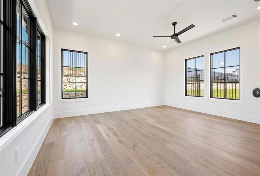 Spare room featuring light wood-type flooring and ceiling fan