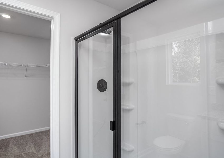 This bathroom has a glass-enclosed shower