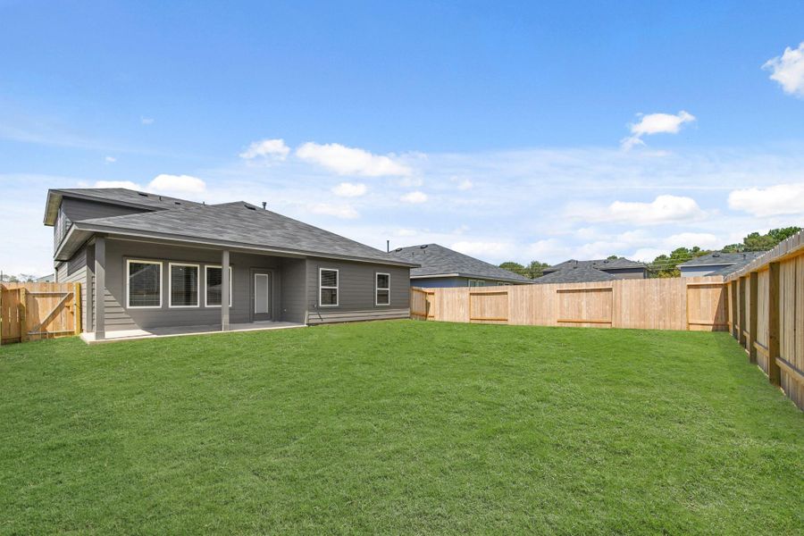 Exterior details and patio area of a home in Grand Pines, Magnolia (Image 13). Exterior details and patio area of a home in Grand Pines, Magnolia (Image 13).