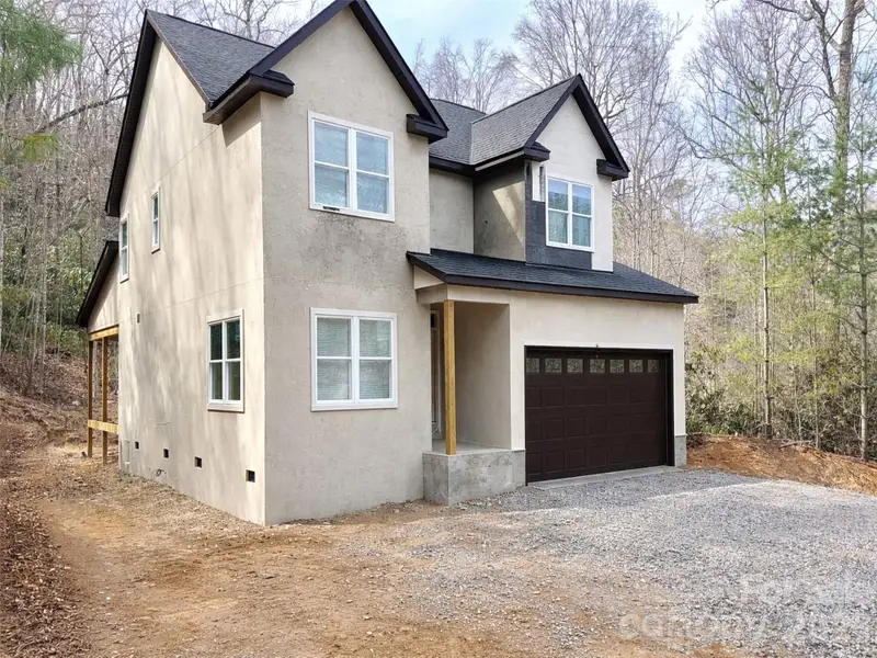 Front exterior of a new home in , Hendersonville, NC, highlighting curb appeal (Image 1). Front exterior of a new home in , Hendersonville, NC, highlighting curb appeal (Image 1).