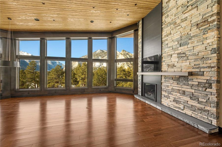 Great room with gas fireplace, staked stone, cedar T&G ceilings and large picture windows with remote controlled translucent shades Great room with gas fireplace, staked stone, cedar T&G ceilings and large picture windows with remote controlled translucent shades