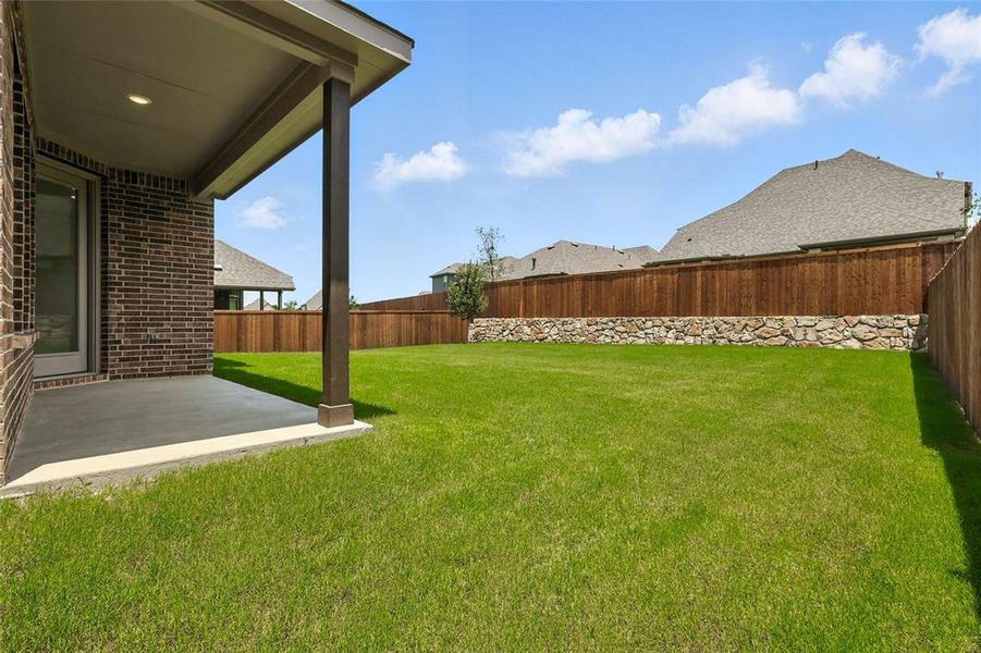 Fenced backyard featuring a patio area Fenced backyard featuring a patio area