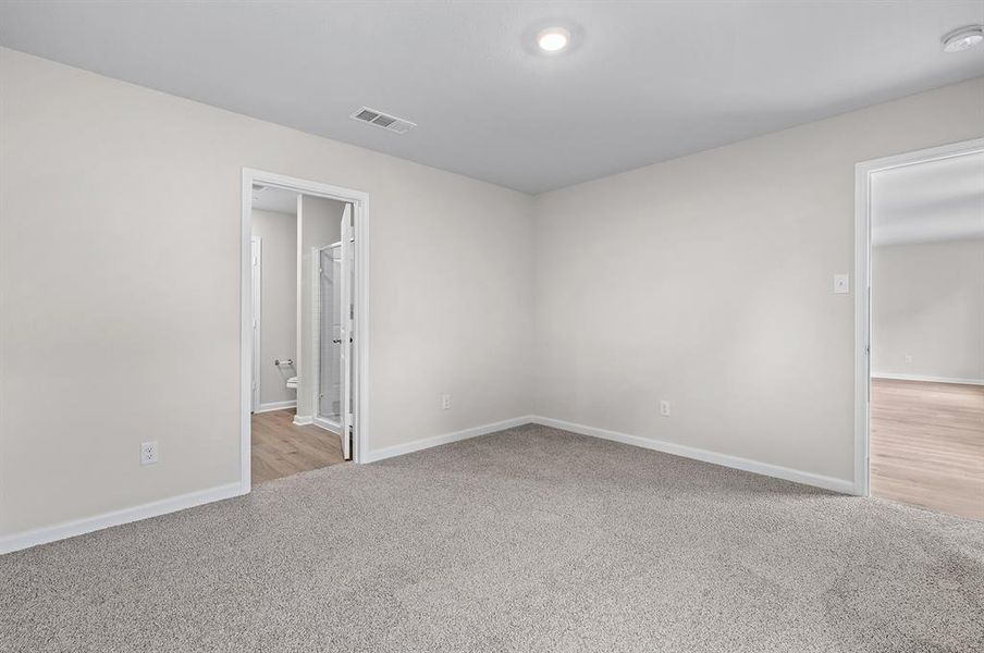 Unfurnished bedroom featuring carpet and baseboards