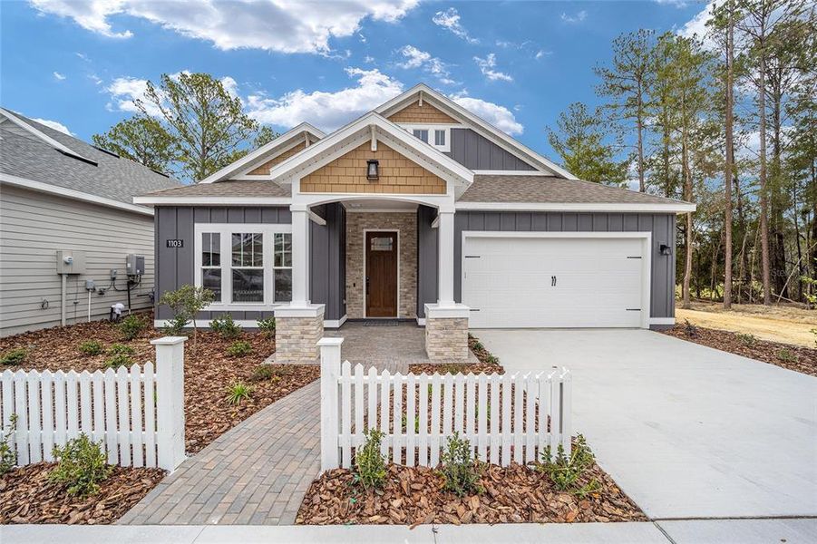Front exterior of a new home in Fairway Pointe at West End, Newberry, FL, highlighting curb appeal (Image 1). Front exterior of a new home in Fairway Pointe at West End, Newberry, FL, highlighting curb appeal (Image 1).