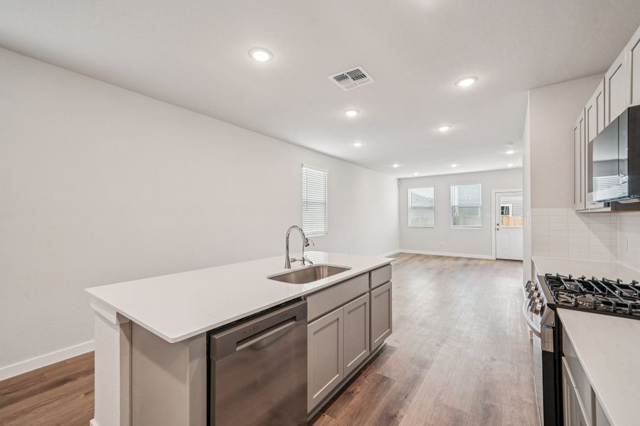 A kitchen with white cabinets.