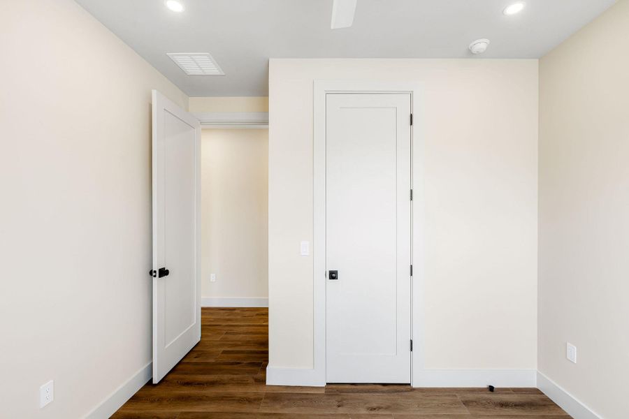 Unfurnished bedroom featuring recessed lighting and dark wood finished floors Unfurnished bedroom featuring recessed lighting and dark wood finished floors