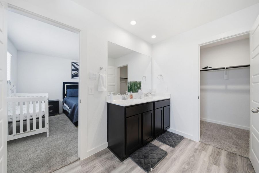 The primary ensuite bathroom features a spacious walk-in closet and a double vanity, offering both functionality and convenience.