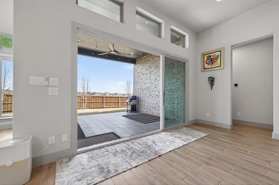 Expansive multi-panel sliding doors open to tiled covered patio. Expansive multi-panel sliding doors open to tiled covered patio.