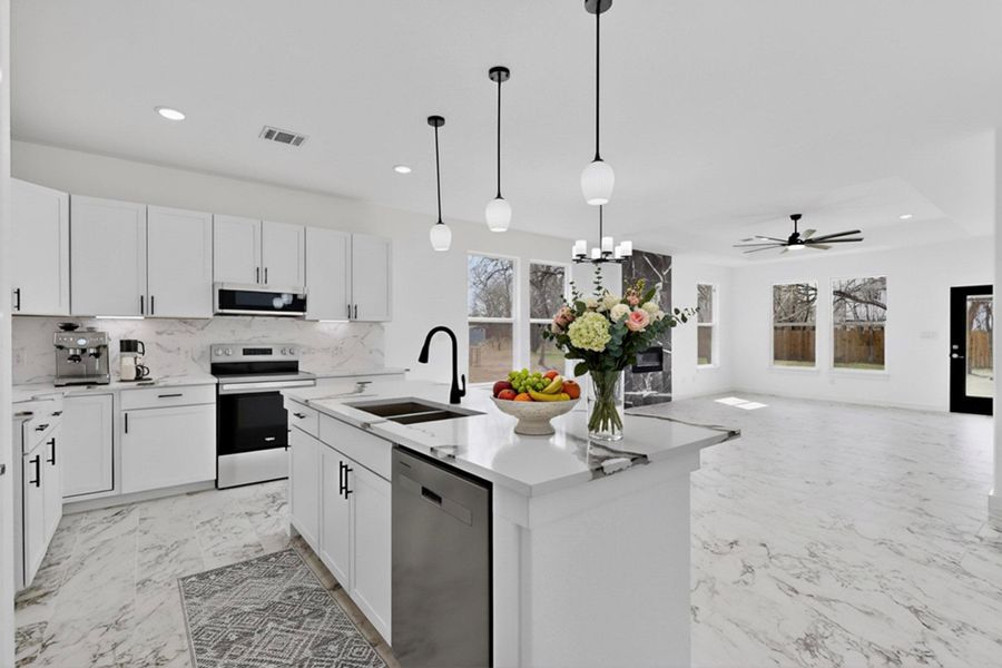 Kitchen featuring stainless steel appliances, white cabinetry, a chandelier, ceiling fan
