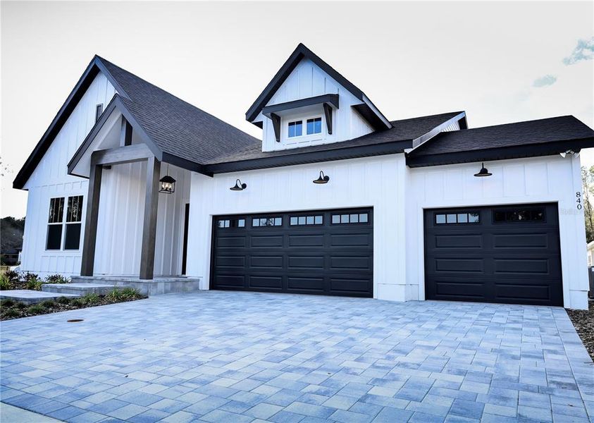 Front exterior of a new home in Laureate Village, Newberry, FL, highlighting curb appeal (Image 1).