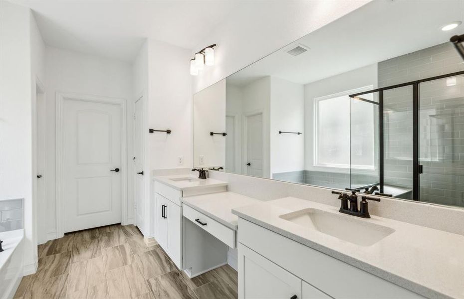 Owner's bathroom with dual vanity and oversized shower*real home pictured