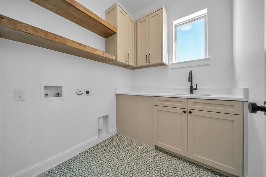 Laundry room with hookup for a washing machine, cabinet space, and hookup for a gas dryer