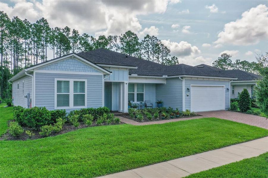 Front exterior of a new home in Reverie at Palm Coast, Palm Coast, FL, highlighting curb appeal (Image 24).