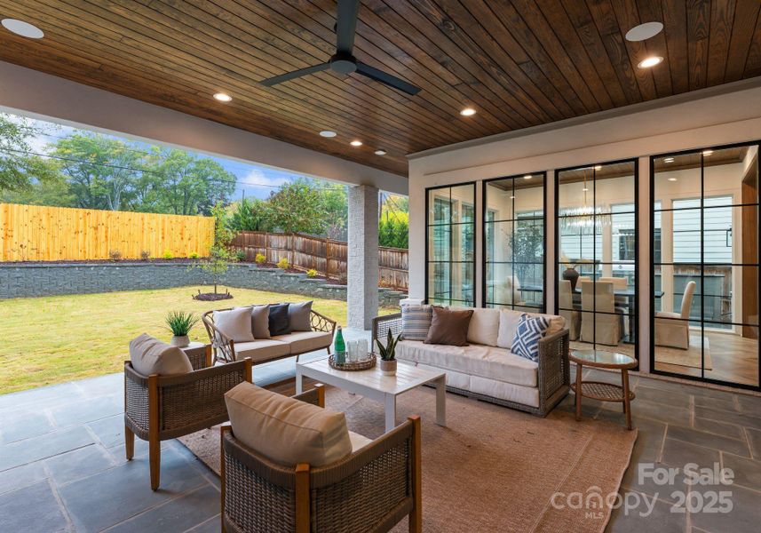 blue stone covered porch with built in speakers and a fireplace